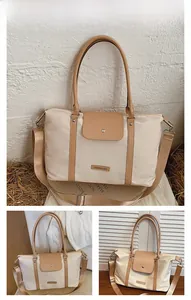 Detail of large capacity beige tote bag with khaki trim and detachable shoulder strap