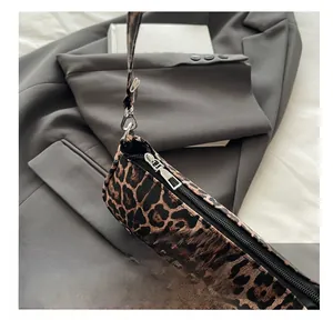 Close-up of smooth silver metal zipper on stylish leopard print shoulder bag
