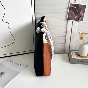 Detail of canvas tote bag with thick cotton rope handles and two-tone stitching