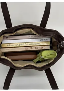 Interior view of large brown tote bag showing spacious capacity for books and umbrella