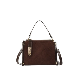 Quilted dark brown suede crossbody bag with gold buckle hardware and top handle