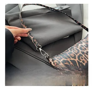Detail shot of silver metal hooks on a leopard print handbag with chic pattern