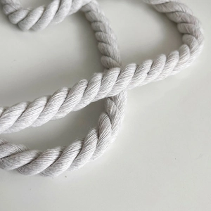 Detailed close-up of thick white twisted cotton rope handle with 3-strand spiral texture