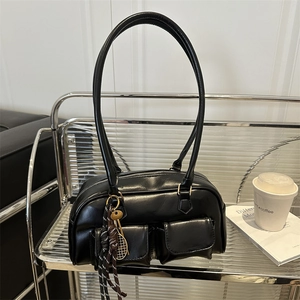 Chic black leather underarm tote bag with utility pockets and metal tennis pendant charms