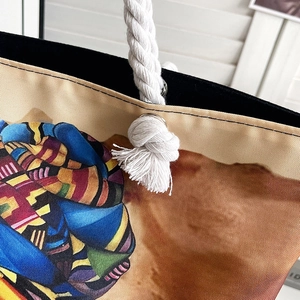 Detail of artistic canvas tote bag with thick cotton rope handle and metal eyelets