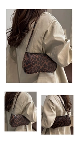 Detail shot of leopard print baguette bag showing texture and shoulder strap fit