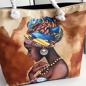 Detail of canvas beach bag with thick cotton rope handles and colorful portrait print