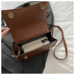 Top view of brown leather crossbody bag showing internal space for a smartphone