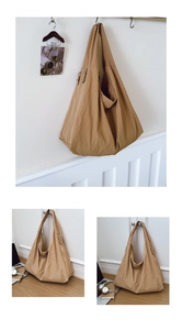 Detailed close-up of khaki textured fabric and zipper on this oversized shoulder bag