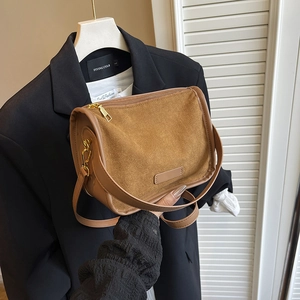 Brown matte suede crossbody bag with gold hardware and stylish minimalist design