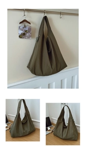 Macro view of olive green oversized nylon tote bag showing textured fabric and zipper detail