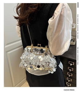 Detail of silver sequin clutch bag with vintage metal clasp and elegant chain strap