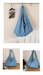 Detailed view of light blue oversized nylon hobo bag with zipper and soft texture