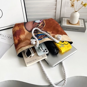 Detail showing high-capacity canvas tote bag storing laptop, umbrella, and sunglasses