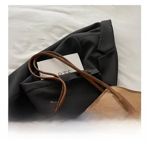 Detailed macro view of caramel lychee grain leather tote bag with metal clasp and handle