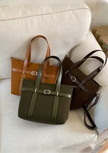 Detailed close-up of woven texture tote bags in yellow, brown and green with leather straps