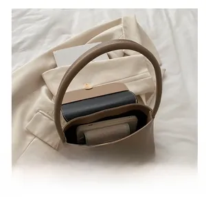 Internal view of beige baguette bag showing capacity for phone and small wallet
