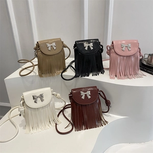 Mini fringe crossbody bag with metallic bow detail available in five retro colors