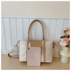 Spacious nylon tote bag with leather trim showing large capacity for a tablet device