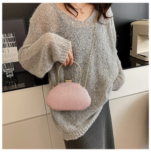 Pink sequin evening bag featuring a gold curved handle and elegant chain strap detail