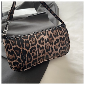 Detailed view of leopard print shoulder bag on a grey blazer for a stylish look