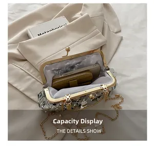 Silver sequin shell bag capacity view showing space for phone and wallet with chain