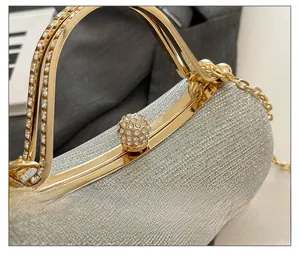 Close-up of sparkling silver glitter evening clutch with rhinestone encrusted ball lock