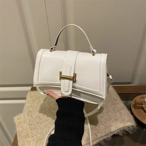Elegant white quilted shoulder bag with golden H-clasp and versatile handle strap