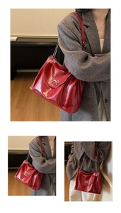 Detail of red faux leather tote bag with silver metal bow and chain shoulder strap