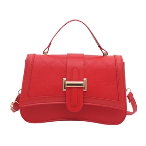 Elegant red quilted crossbody bag with gold-tone buckle and adjustable shoulder strap
