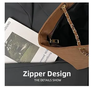 Detail view of the secure zipper closure and metal chain strap on the leopard tote bag