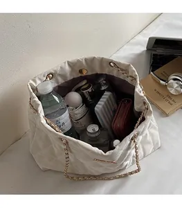 Close-up of white quilted tote bag interior showing spacious capacity for daily essentials