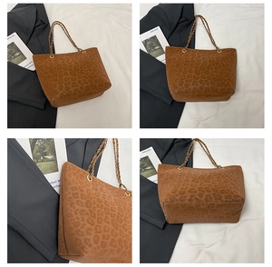 Detail view of large leopard print tote bag with gold chain and leather handles