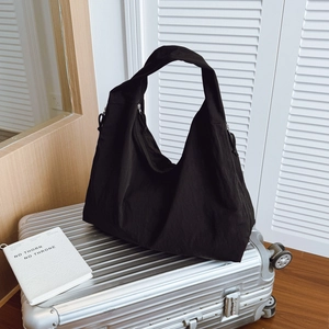 Minimalist black large capacity nylon hobo shoulder bag with casual textured finish