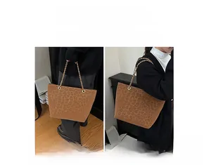 Close-up of leopard print tote bag with gold chain strap for shoulder and hand carrying