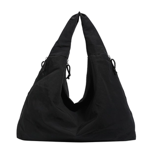 Large black minimalist hobo bag with drawstring sides and wide shoulder strap