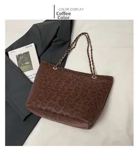 Detail of coffee leopard print tote bag with gold metal chain and suede texture