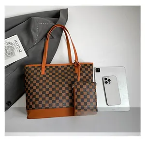 Detail view of checkerboard tote bag set with brown leather trim and matching pouch