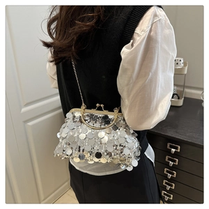 Detailed view of shiny silver sequin evening bag with gold clasp and delicate chain strap
