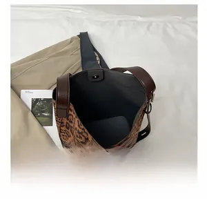Detailed interior of the leopard print tote showing large capacity and magnetic buckle
