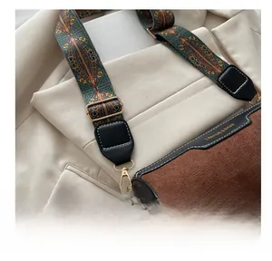 Detail shot of the adjustable buckle on the vintage brown cylinder bag's wide strap