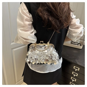 Detail of silver sequin evening bag with gold kiss-lock closure and metal chain strap