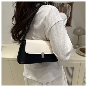Detail of the high-end color-blocking shoulder bag with vintage metal buckle and strap