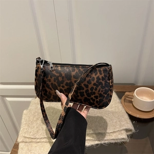 Fashionable leopard print leather baguette shoulder bag with silver zipper and slim strap