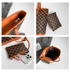 Detail view of brown checkered tote with mini pouch, zipper hardware, and orange lining