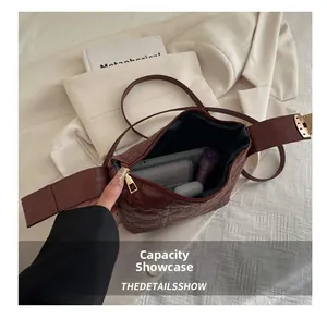 Detailed internal view showing the capacity of this red quilted crossbody handbag