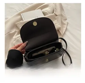 Internal storage view of vintage leather crossbody bag with magnetic buckle closure