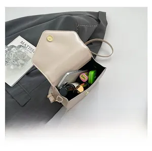 Internal view of beige faux leather handbag showing capacity for phone and cosmetics