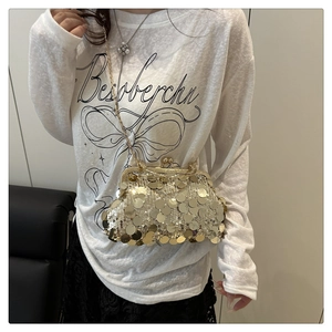 Detail of elegant gold sequin clutch bag with vintage metal clasp and slim chain strap