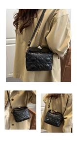 Close-up of black heart quilted handbag with elegant gold hardware and adjustable strap